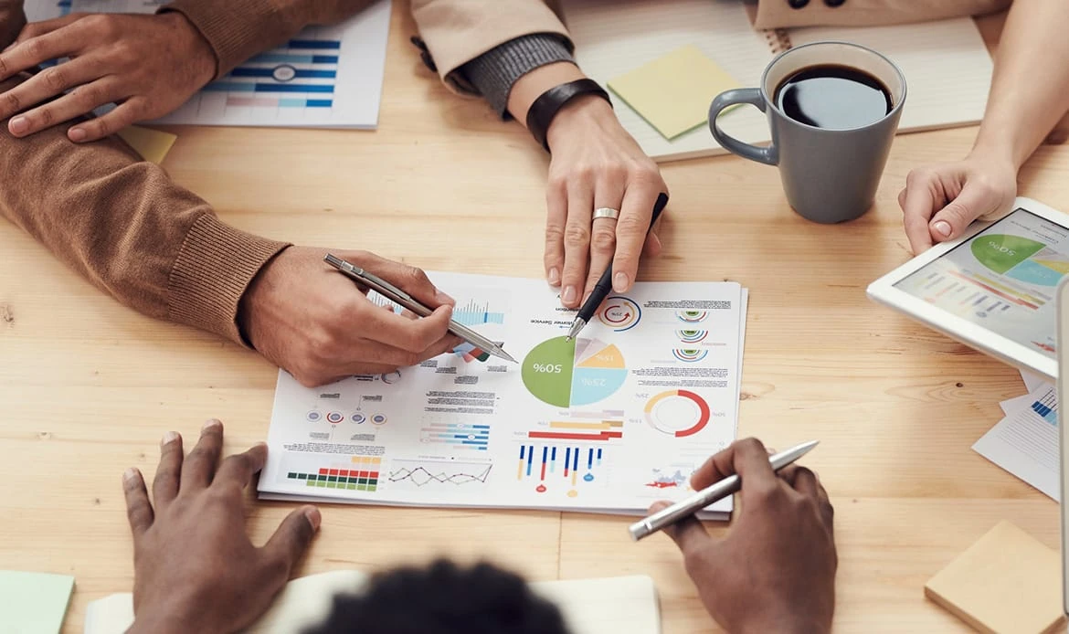 A team working together around marketing charts